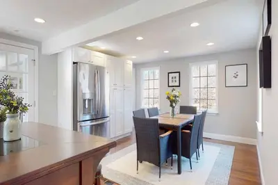 a kitchen with a table and chairs and a refrigerator at White Oaks in Branford