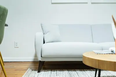 a white couch in a living room with a table at 49-4A Prime Midtown newly 2BR WD in New York