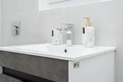 a bathroom sink with two soap bottles on it at 49-4A Prime Midtown newly 2BR WD in New York
