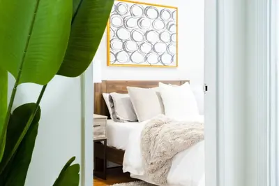 a bedroom with a bed with white sheets and pillows at 49-4A Prime Midtown newly 2BR WD in New York