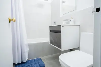 a white bathroom with a toilet and a shower at 49-4A Prime Midtown newly 2BR WD in New York