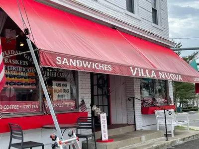a restaurant with a red awning on a street at One bedroom with modern kitchen, balcony with water view in Greenwich