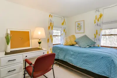 a bedroom with a bed and a desk with a tv at Milford Family Home with Koi Pond and Porch! in West Milford