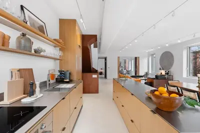 a kitchen with a bowl of oranges on a counter at 4BR Greenpoint Duplex Noorman by RoveTravel in Brooklyn
