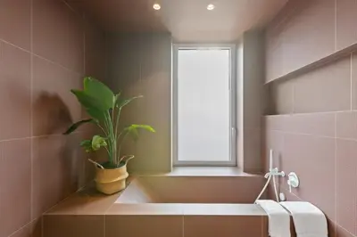 a bathroom with a sink and a window and a plant at 4BR Greenpoint Duplex Noorman by RoveTravel in Brooklyn