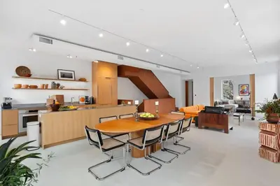 a kitchen and living room with a wooden table and chairs at 4BR Greenpoint Duplex Noorman by RoveTravel in Brooklyn