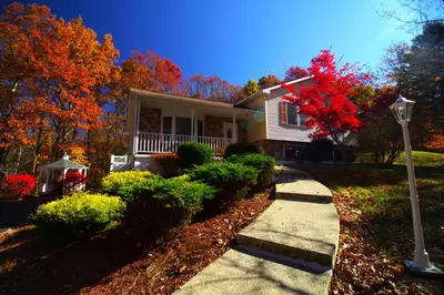 a house with a street light in front of it at Stunning Poconos Villa- Hot Tub, Pool, Game Room, BBQ & more in East Stroudsburg