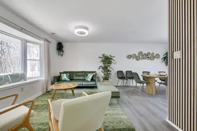 a living room with a couch and a table at Stunning Poconos Villa- Hot Tub, Pool, Game Room, BBQ & more in East Stroudsburg