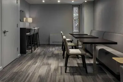 a dining room with tables and chairs and a counter at UWS 1BR w Doorman Gym Parking nr Central Park NYC-596 in New York