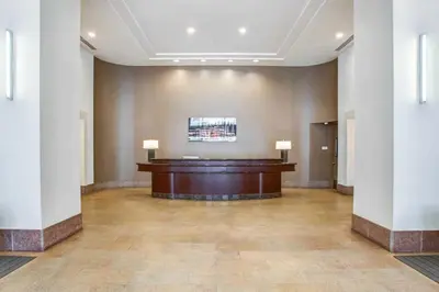 a large room with a desk in a building at UWS 1BR w Doorman Gym Parking nr Central Park NYC-596 in New York