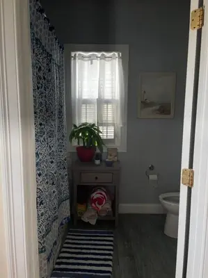 a bathroom with a toilet and a window at A little place in the Sun in Milford