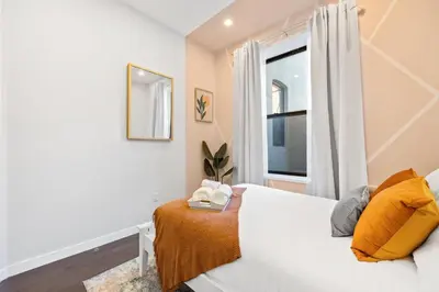 a bedroom with a white bed and a window at SWJ 1st - Near Most Attractions Walk to Train Times Sq near in New York