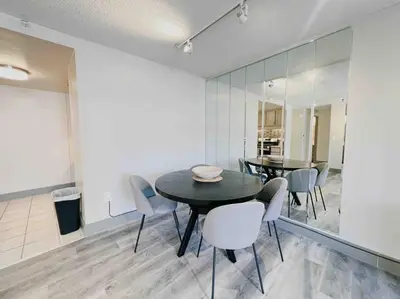 a dining room with a black table and chairs at Downtown Hartford Condo - XL Center in Hartford