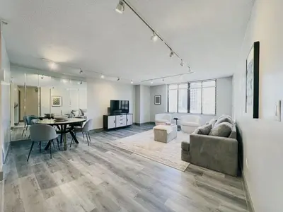 a living room with a couch and a table at Downtown Hartford Condo - XL Center in Hartford