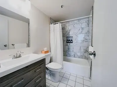 a bathroom with a sink and a toilet and a shower at Downtown Hartford Condo - XL Center in Hartford