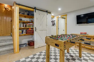a foosball table in the middle of a room at Honey Paws Inn Wilmington Home 6 Mi to Mount Snow in Wilmington