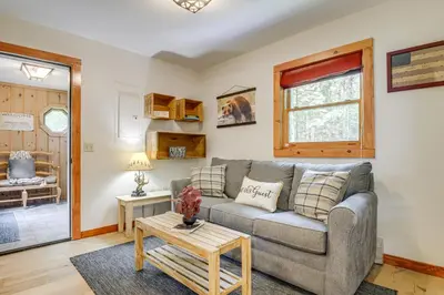 a living room with a couch and a table at Honey Paws Inn Wilmington Home 6 Mi to Mount Snow in Wilmington