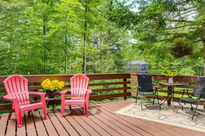 three chairs and a table on a wooden deck at Honey Paws Inn Wilmington Home 6 Mi to Mount Snow in Wilmington
