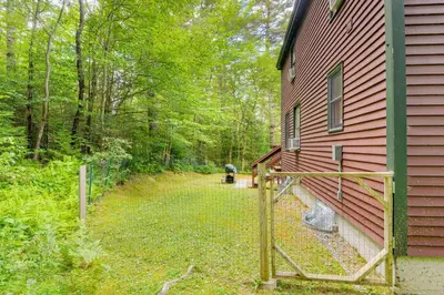 a yard next to a house with a fence at Honey Paws Inn Wilmington Home 6 Mi to Mount Snow in Wilmington
