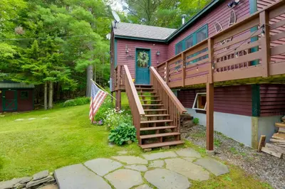 a pink house with a staircase leading up to the door at Honey Paws Inn Wilmington Home 6 Mi to Mount Snow in Wilmington