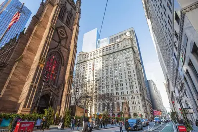 a tall building with a clock tower in a city at FiDi 1br w lounge gym nr Freedom Tower NYC-1138 in New York