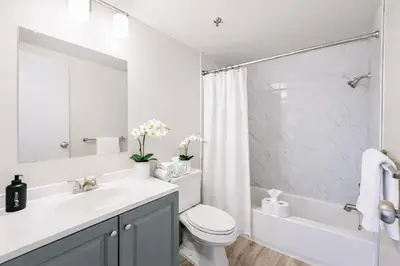 a bathroom with a sink and a toilet and a shower at The Hartford Skyline - Stylish Downtown Condo with Wifi Gym in Hartford
