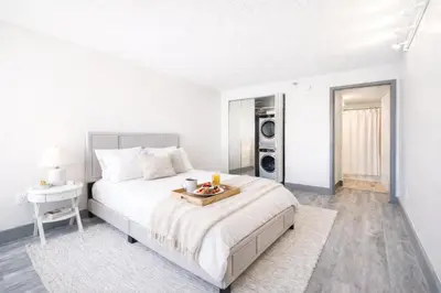 a bedroom with a bed with a tray of food on it at The Hartford Skyline - Stylish Downtown Condo with Wifi Gym in Hartford