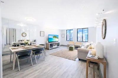 a living room with a table and a couch at The Hartford Skyline - Stylish Downtown Condo with Wifi Gym in Hartford