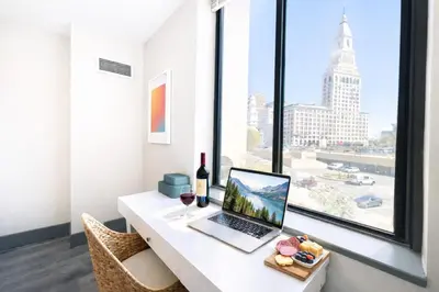 a laptop computer sitting on a desk in front of a window at The Hartford Skyline - Stylish Downtown Condo with Wifi Gym in Hartford