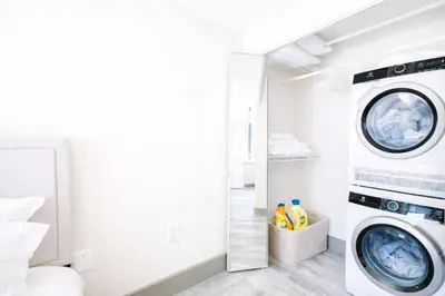 a laundry room with a washer and dryer at The Hartford Skyline - Stylish Downtown Condo with Wifi Gym in Hartford