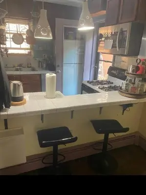 a kitchen with two stools and a counter in a kitchen at Rock Pad for Yale, Visitors, Nurses, Staff in New Haven