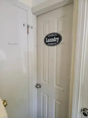 a white door with a laundry sign on it at Rock Pad for Yale, Visitors, Nurses, Staff in New Haven