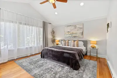 a bedroom with a bed and a ceiling fan at New Beach Home near Stamford Downtown/Shippan in Stamford