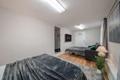 a bedroom with a bed and a couch in a room at New Beach Home near Stamford Downtown/Shippan in Stamford