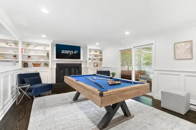 a living room with a pool table and a tv at New Beach Home near Stamford Downtown/Shippan in Stamford