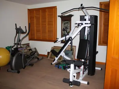 a gym with three exercise bikes in a room at Honey Maple Grove BnB in Bedford