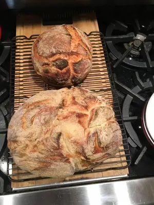 two loaves of bread sitting on a rack in an oven at Honey Maple Grove BnB in Bedford