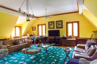a living room with a couch and a tv at Honey Maple Grove BnB in Bedford