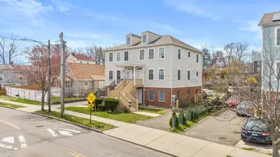 a large white house with a staircase in a street at Gorgeous Waterfront 2 Bedroom 1 Bath Modern Home. in New Haven