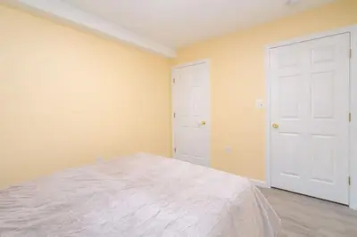 a bedroom with a bed and two white doors at Gorgeous Waterfront 2 Bedroom 1 Bath Modern Home. in New Haven