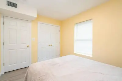 a bedroom with a large bed and a window at Gorgeous Waterfront 2 Bedroom 1 Bath Modern Home. in New Haven