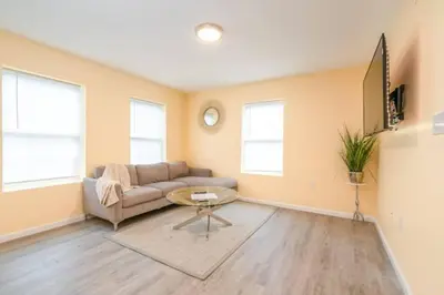 a living room with a couch and a table at Gorgeous Waterfront 2 Bedroom 1 Bath Modern Home. in New Haven