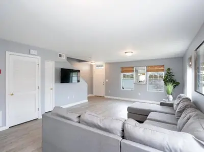 a living room with a couch and a tv at Gorgeous Waterfront 3 Bedroom, 1.5 Bathroom Unit. in New Haven