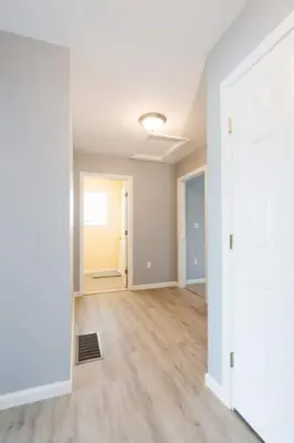 an empty living room with white walls and wood floors at Gorgeous Waterfront 3 Bedroom, 1.5 Bathroom Unit. in New Haven