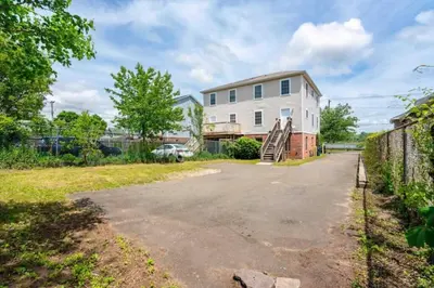 an empty driveway in front of a house at Gorgeous Waterfront 3 Bedroom, 1.5 Bathroom Unit. in New Haven