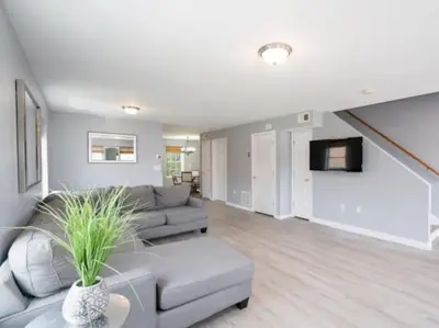 a living room with a couch and a tv at Gorgeous Waterfront 3 Bedroom, 1.5 Bathroom Unit. in New Haven