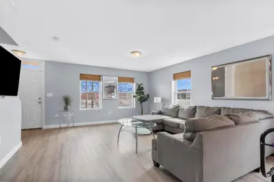 a living room with a couch and a table at Gorgeous Waterfront 2:1 - 2 houses in 1 building. in New Haven