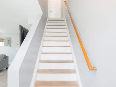 a staircase in a house with white walls and wooden floors at Gorgeous Waterfront 2:1 - 2 houses in 1 building. in New Haven