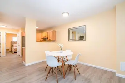 a dining room with a white table and chairs at Gorgeous Waterfront 2:1 - 2 houses in 1 building. in New Haven