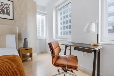 a bedroom with a desk and a bed and a desk at Midtown 1br w doorman gym wd nr Rock Center NYC-1127 in New York